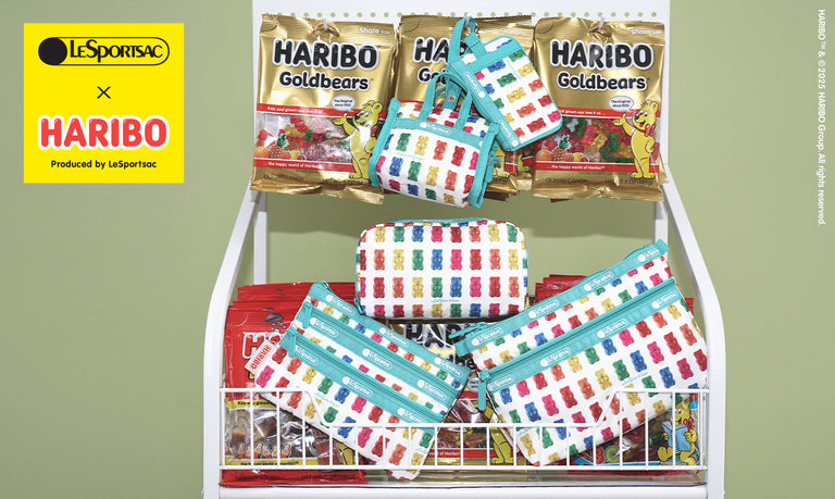LeSportsac x HARIBO collection featuring colorful gummy bear print accessories, including pouches and bags, displayed next to HARIBO Goldbears candy bags.