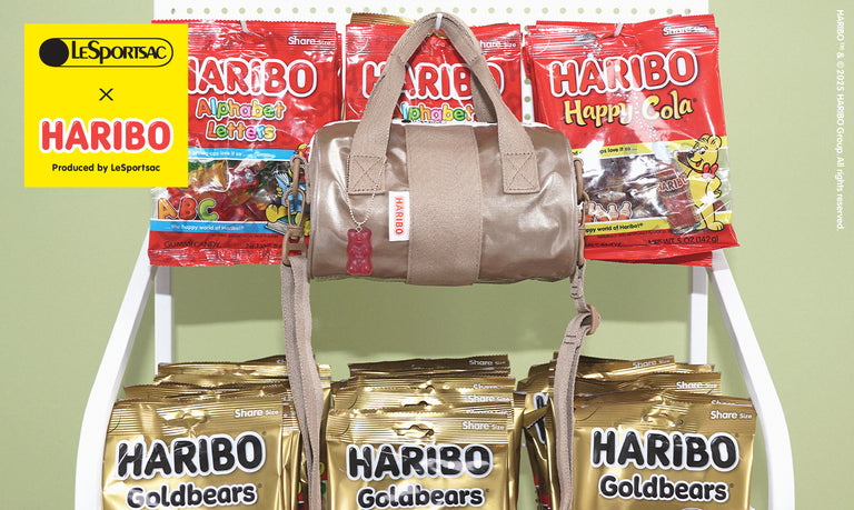 LeSportsac x HARIBO collaboration featuring a beige crossbody bag with a gummy bear zipper pull, displayed alongside various HARIBO candy bags.