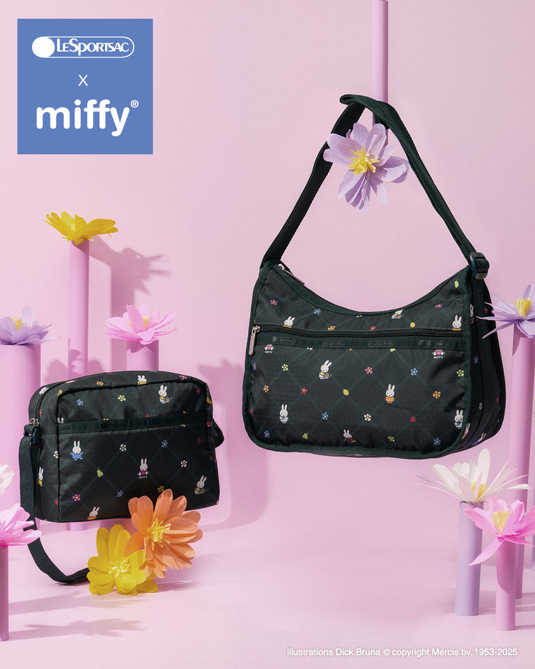 Two LeSportsac x Miffy bags in the Miffy Orchard print displayed against a pink background with pastel flowers. The Classic Hobo shoulder bag hangs at right, the Daniella Crossbody sits at left, all featuring a dark green quilted background with small Miffy characters and colorful floral details.